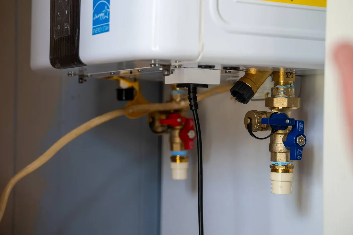 Close-up of the isolation valves under a tankless water heater