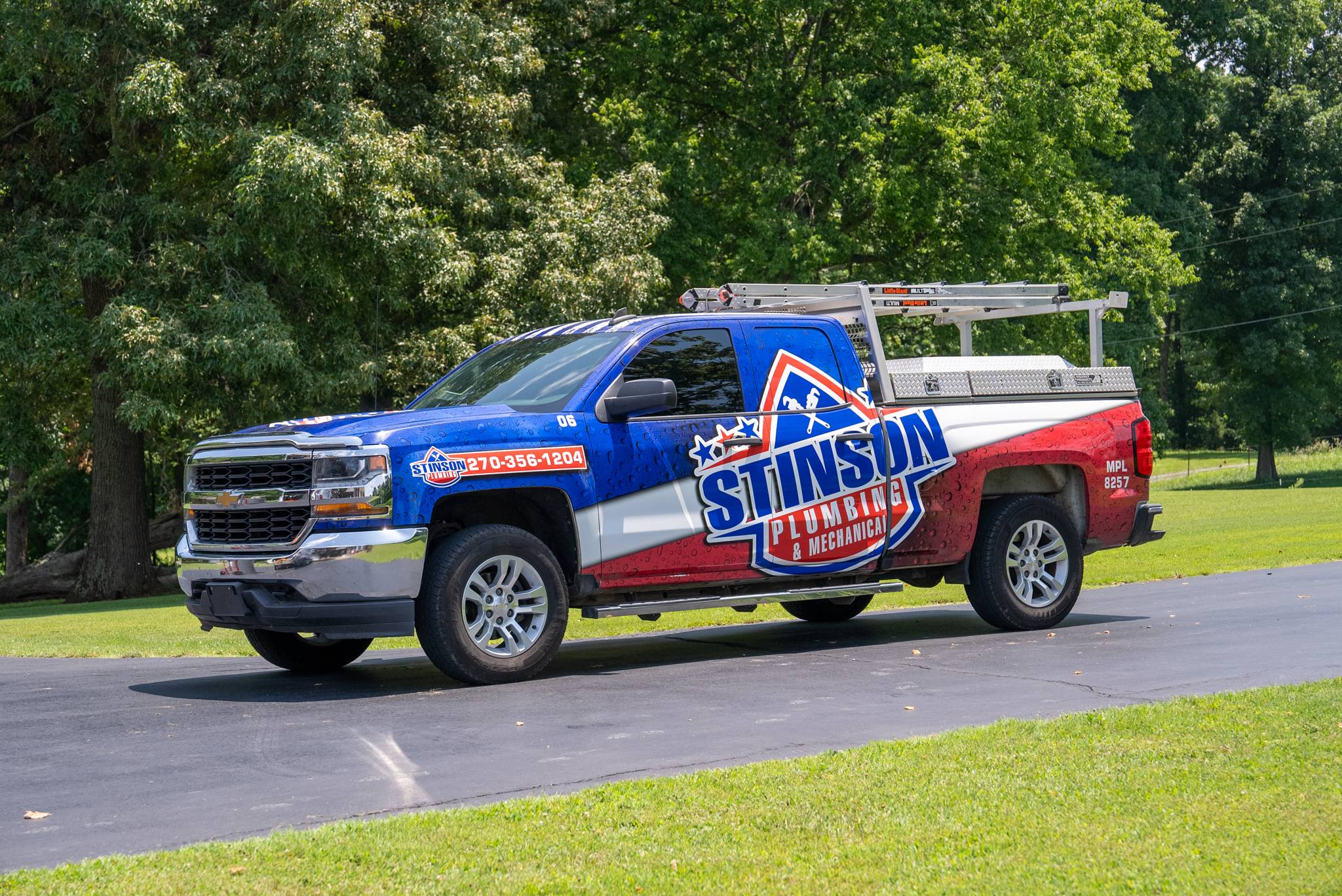 Marked Stinson Plumbing service truck on a rural western Kentucky road