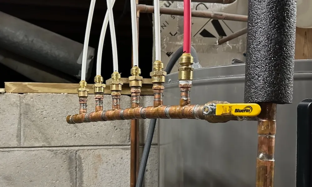 Hot water manifold installed in an Owensboro, KY basement utility area